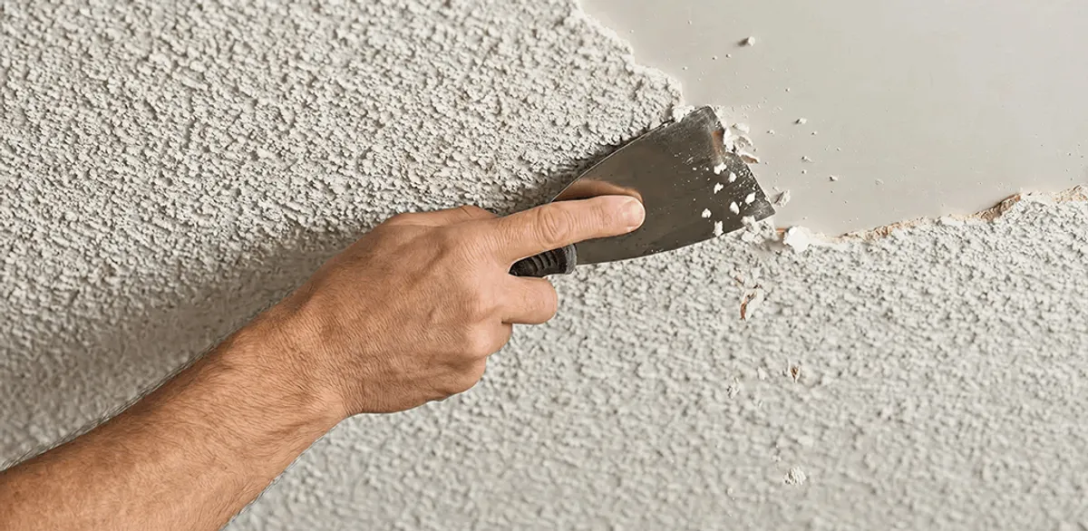 Popcorn ceiling removal scraping off textured ceiling finish in Manchester, NH